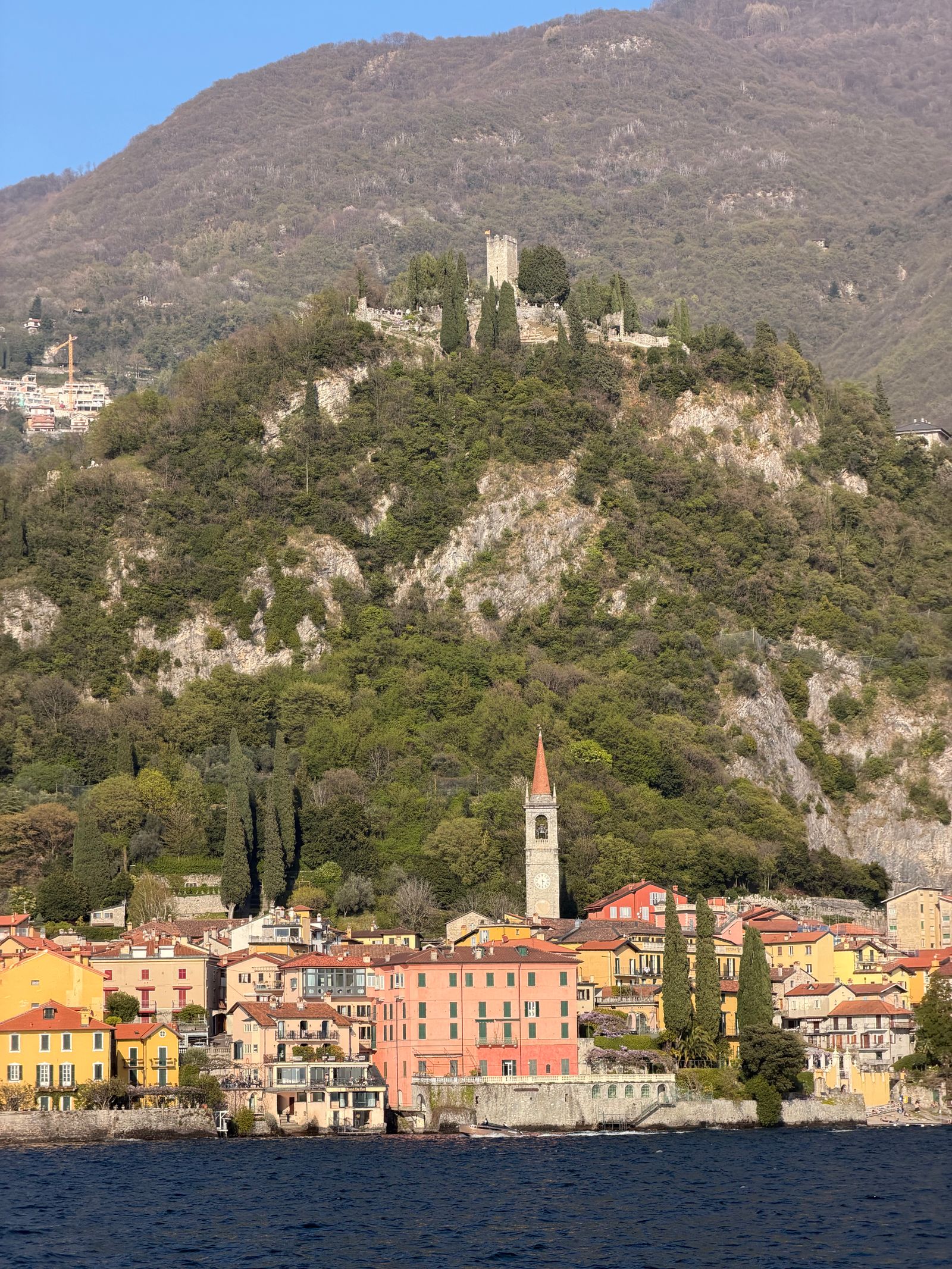 Colorful waterfront and green hills on Lake Como, Italy